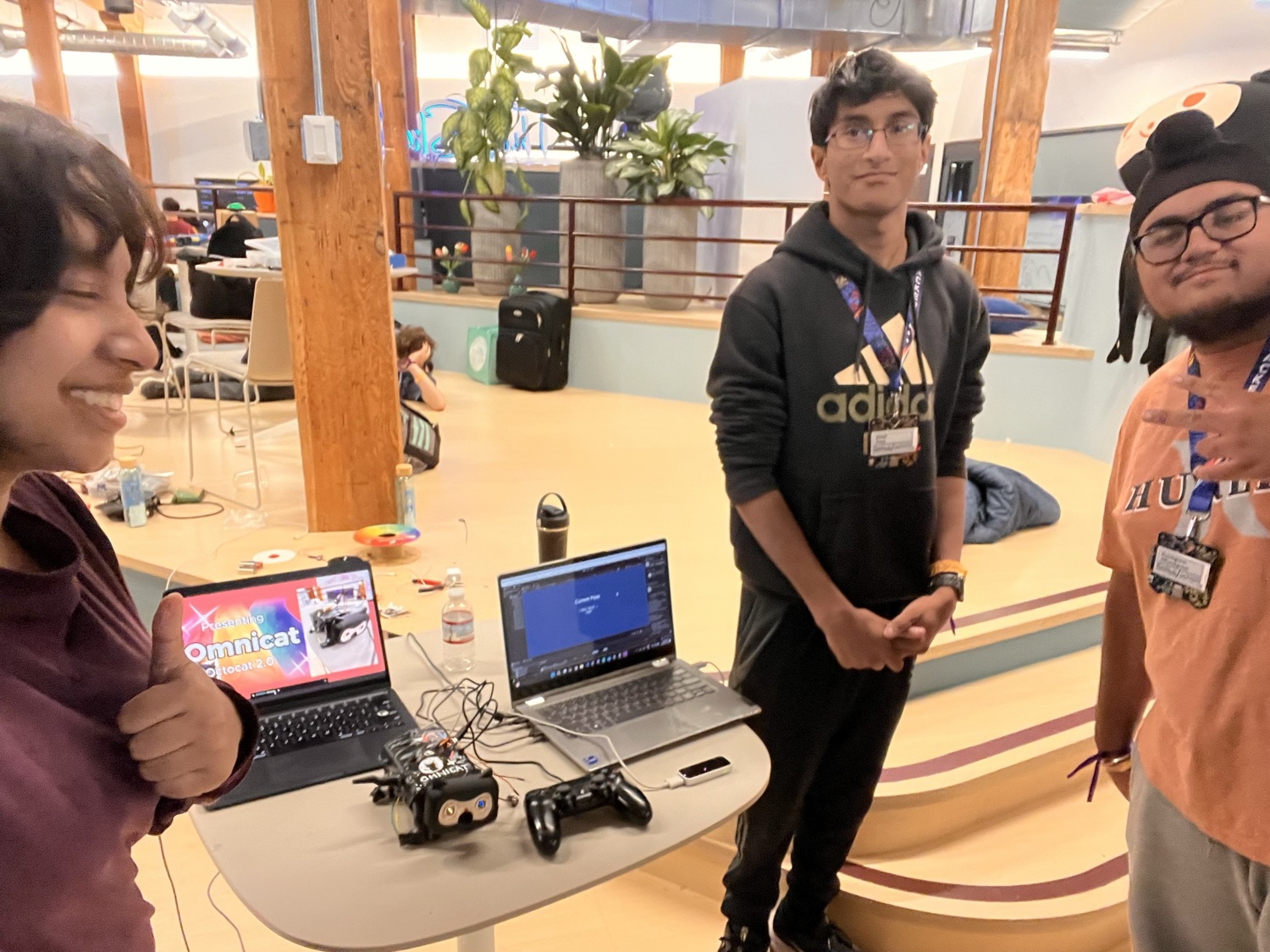 Friends showing off a robotics project at a build event